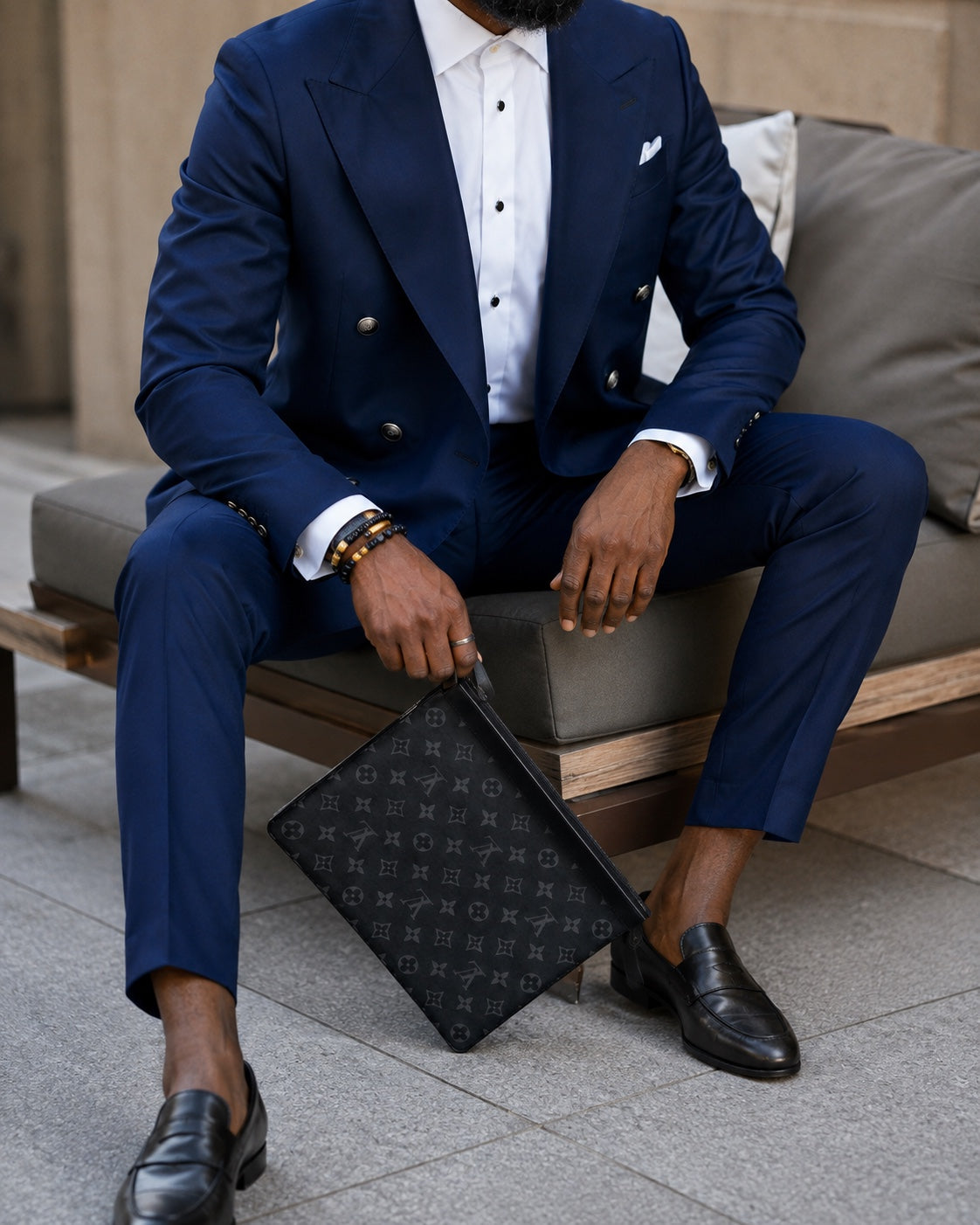 Seated model wearing a navy custom suit